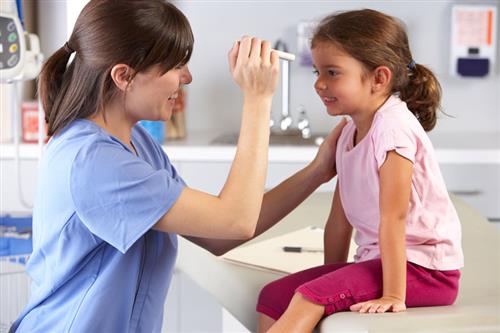 School nurse examines girl 